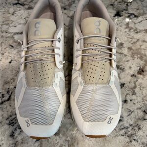 On Running Cream and White Athletic Shoes